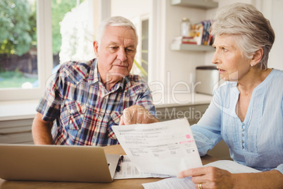 Worried senior couple discussing their bills