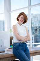 smiling hipster business woman with her arms crossed