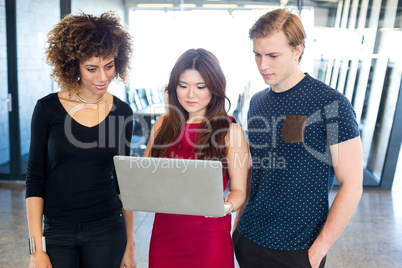 Colleagues discussing in laptop