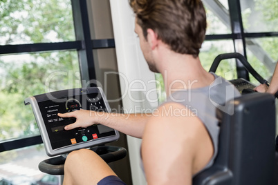 Fit man doing exercise bike Fit man doing exercise bike