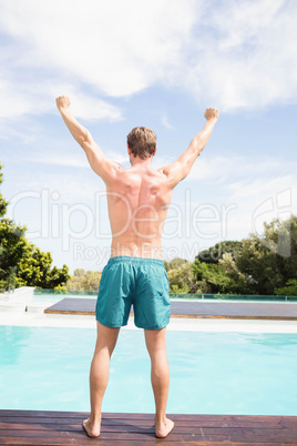 Young man standing near poolside