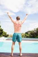 Young man standing near poolside