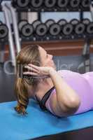 Woman doing abdominal crunches on mat