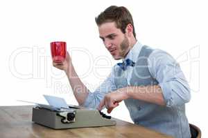 Handsome man using old fashioned typewriter