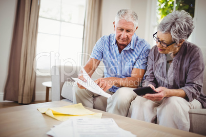 Senior man showing documents to woman