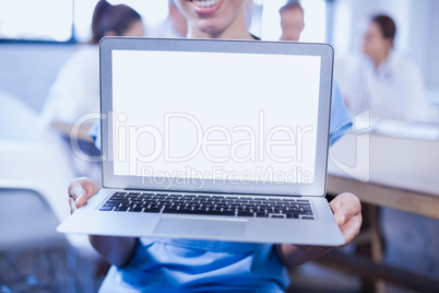 Close-up of female doctor showing laptop