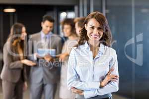 Confident businesswoman looking at camera in office