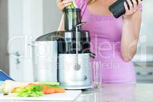 Woman preparing a smoothie in the kitchen