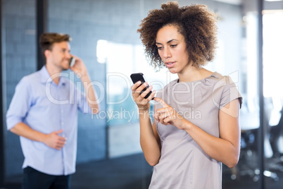 Colleagues communicating on mobile phone