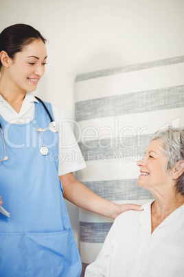 Nurse taking care of sick senior woman