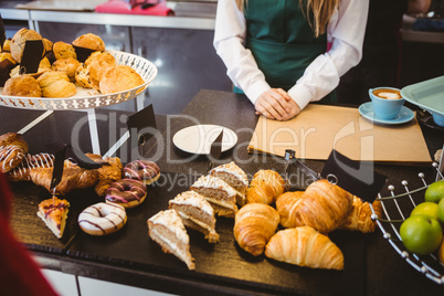 Waitress standing behind the counter