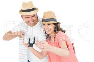 Happy couple using a selfie stick