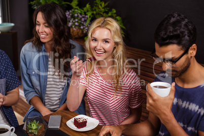 Smiling blonde enjoying a pastry