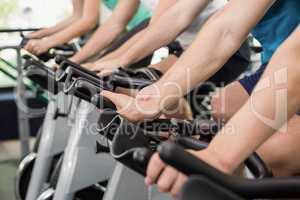 Fit group of people using exercise bike together