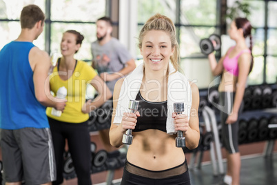 Fit woman posing with athletic women and man behind