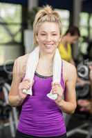 Fit woman smiling and holding towel