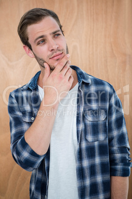 Handsome hipster with hand on chin