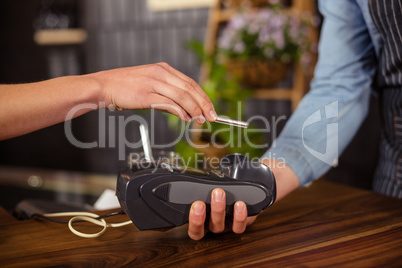 Female customer paying with smartphone