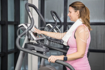 Pregnant woman on crosstrainer