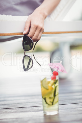 Close-up of womans hand holding sunglasses