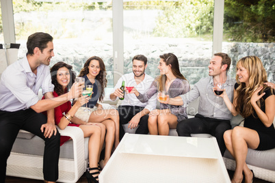 Group of friends talking and having drinks