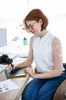 thoughtful hipster businesswoman with a digital drawing tablet