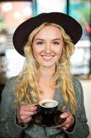 Smiling blonde drinking a coffee