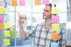 Hipster man pointing at post-it