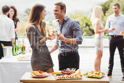 Happy young friends having drinks