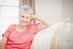 Happy senior woman sitting on sofa