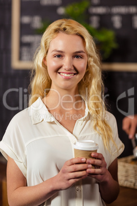 Pretty customer holding takeaway cup