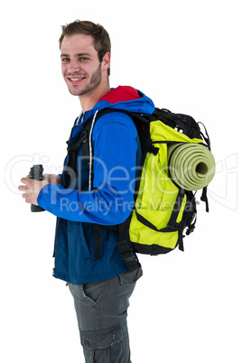 Side view of backpacker holding binoculars