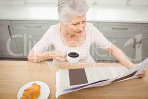 Senior woman reading a newspaper