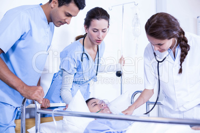 Doctors examining a patient on bed