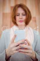 Red haired hipster using smartphone