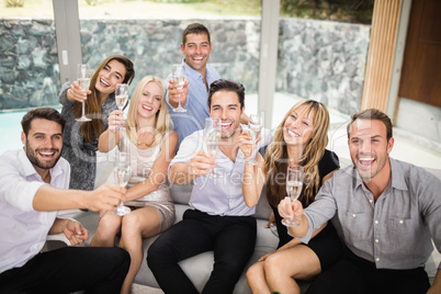 Group of friends holding glasses of champagne