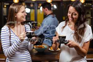 Smiling friends having coffee