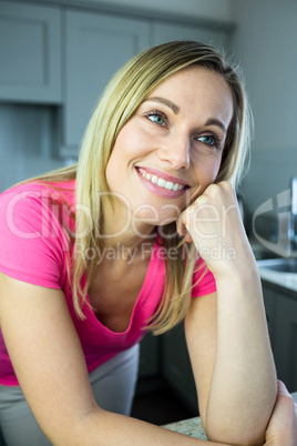 Pretty blonde woman leaning on the counter