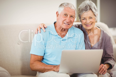 Senior couple sitting on sofa