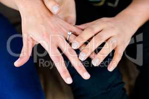 Woman putting a ring on her partners finger