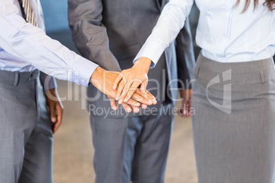 Close-up of businesspeople stacking hands