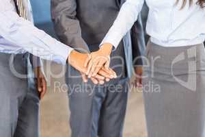 Close-up of businesspeople stacking hands