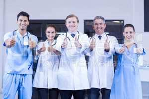 Medical team putting their thumbs up and smiling