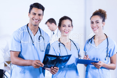 Portrait of doctors holding a x- ray and smiling