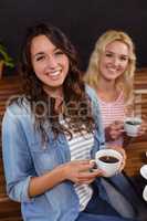 Smiling friends enjoying coffee together
