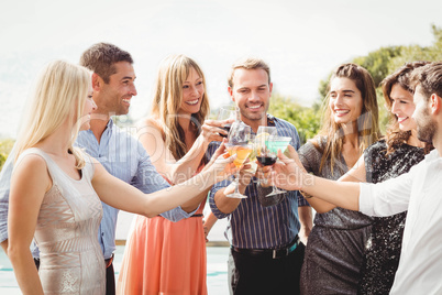 Happy young friends having drinks