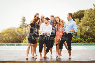 Happy young friends having drinks