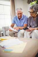 Senior man showing documents to woman