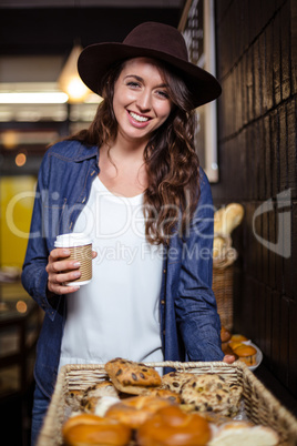 Smiling woman holding disposable cup