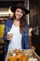 Smiling woman holding disposable cup
